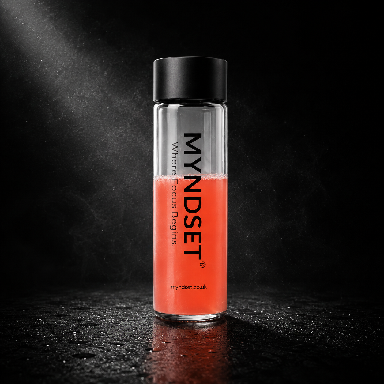 Bottle with red liquid and black cap on a dark background, featuring the MYNDSET brand.